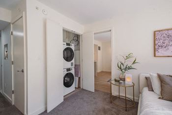a living room with a washing machine and a dryer in it